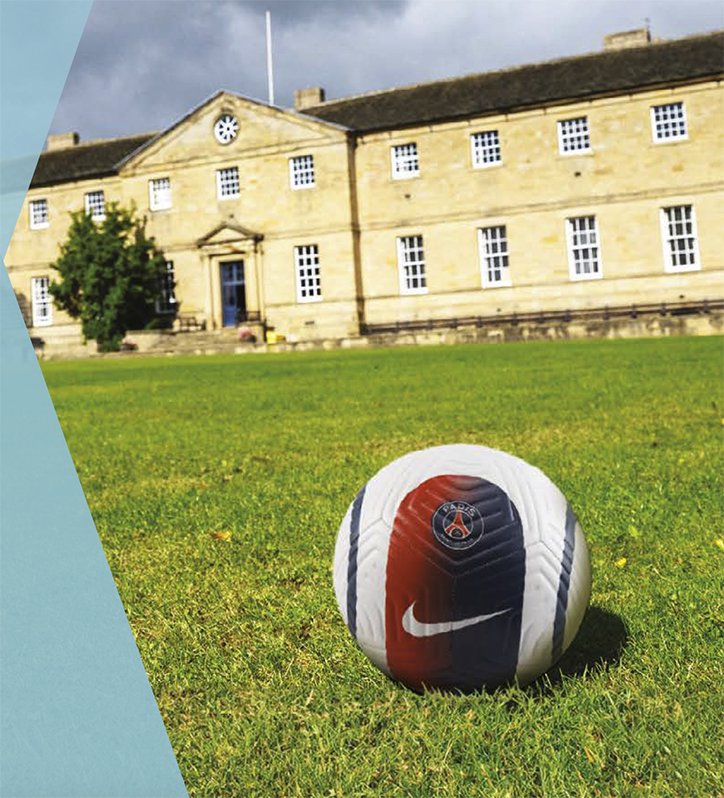 Football on the grass with the Ackworth School heritage building behind