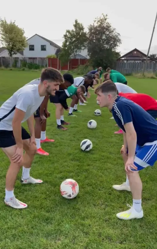 Players stretching with footballs